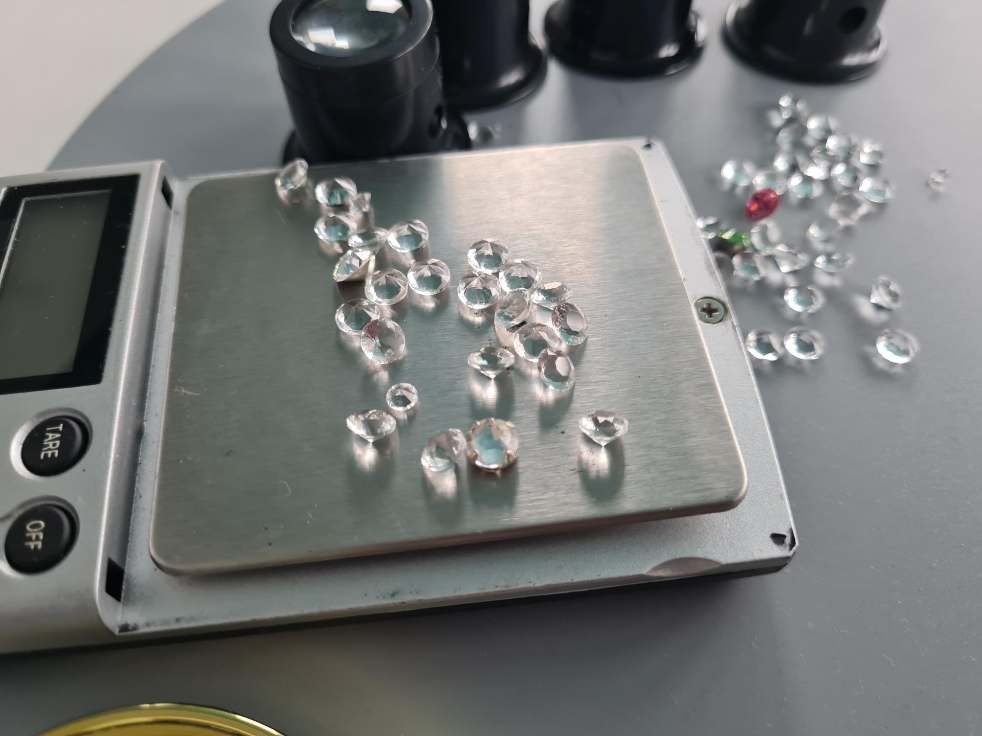 Gems on jewelry scales closeup