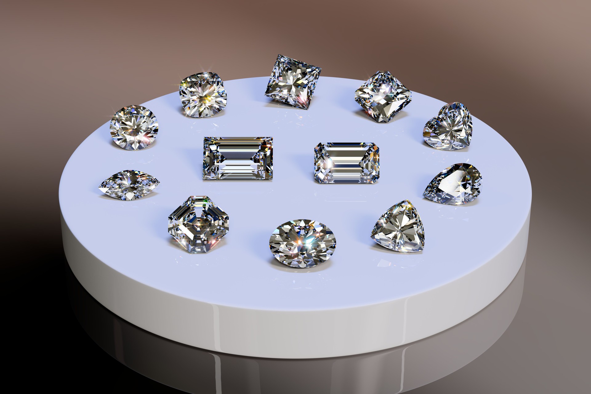Twelve diamonds of popular cut styles on white glossy tray on gray background